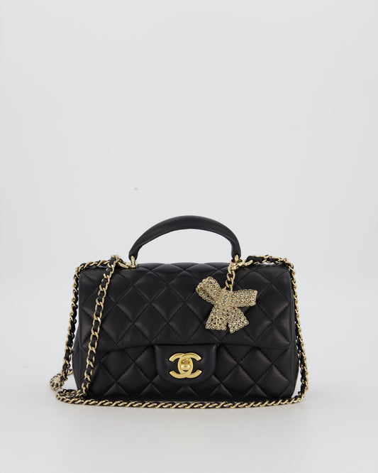 Chanel Black Mini Rectangular Top Handle Flap Bag in Lambskin Leather with Champagne Hardware and Strass Removable Bow Charm