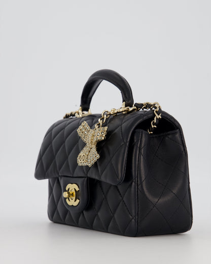 Chanel Black Mini Rectangular Top Handle Flap Bag in Lambskin Leather with Champagne Hardware and Strass Removable Bow Charm