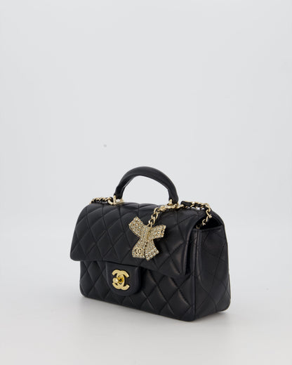 Chanel Black Mini Rectangular Top Handle Flap Bag in Lambskin Leather with Champagne Hardware and Strass Removable Bow Charm